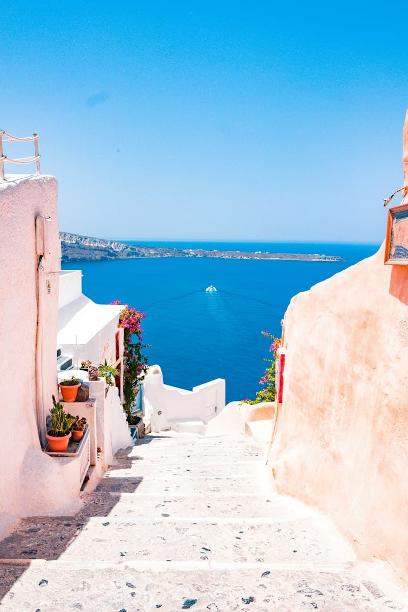 Sun-drenched pastel cliffside village cascading down to the azure sea on the Amalfi Coast