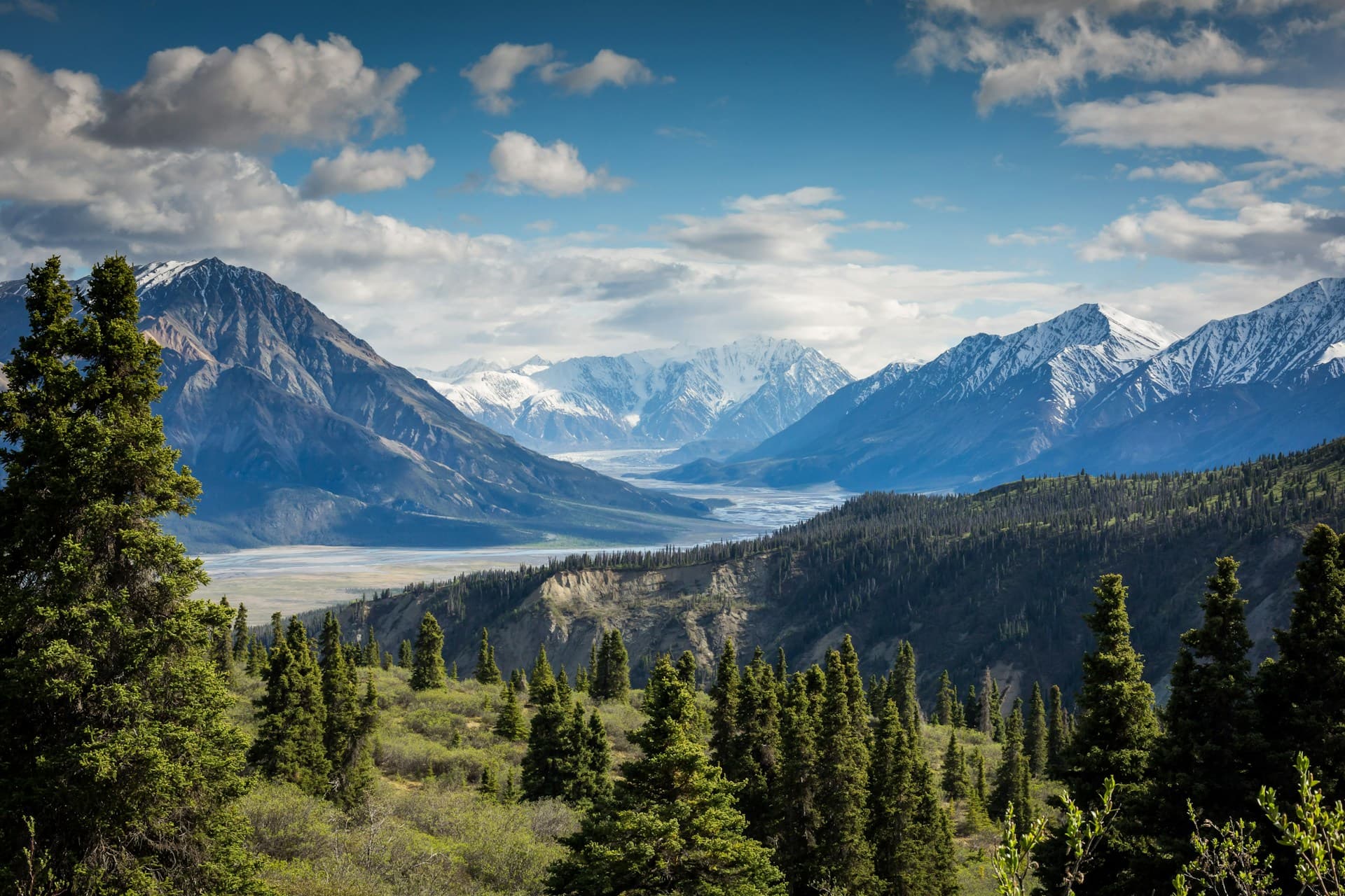 Panoramic alpine mountain peaks and crystal glacial lake